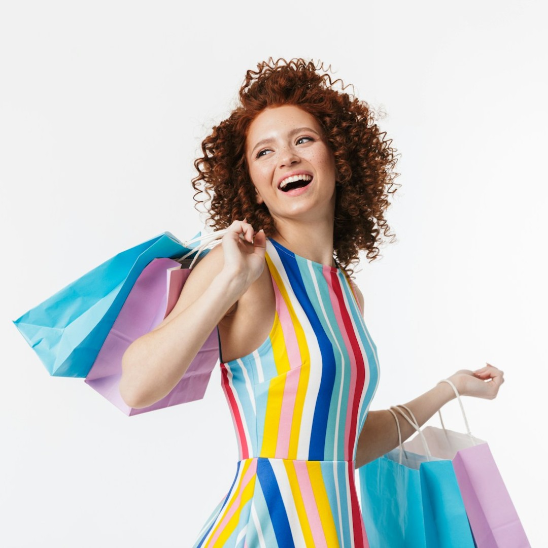Happy woman holding shopping bags